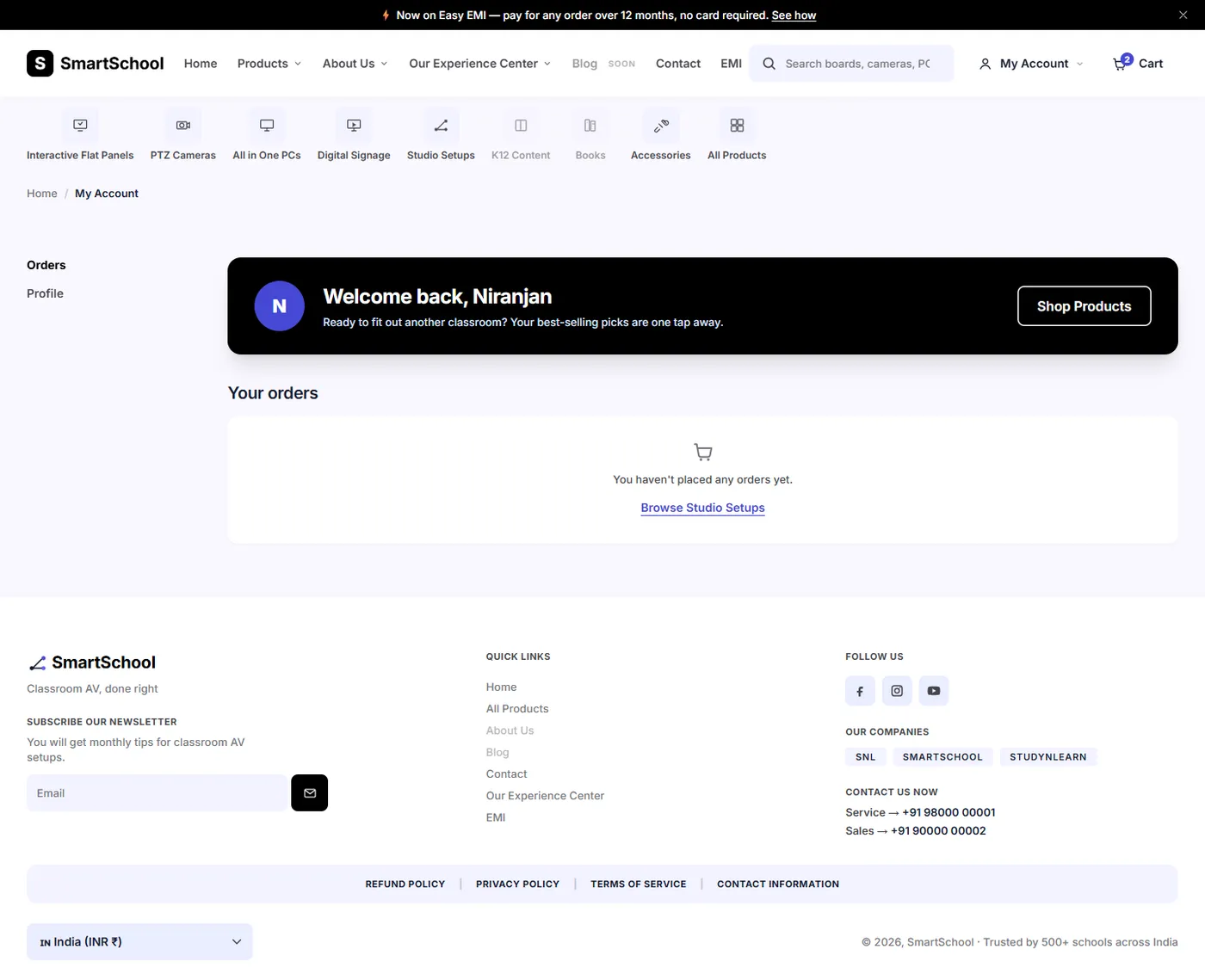 The My Account page on a laptop, with Orders and Profile tabs, a black Welcome back, Niranjan panel and an orders card that says no orders have been placed yet